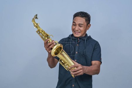 A man holding a Saxophone