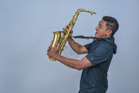 A man holding a Saxophone