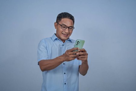 Man in glasses holding smartphone