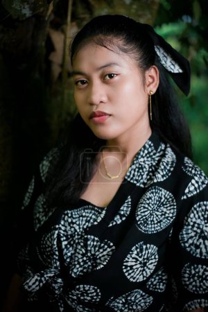 Young girl model with typical Indonesian face in the park
