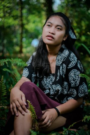 Young girl model with typical Indonesian face in the park