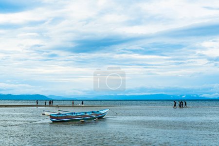 Boat on the beach cloudy blue sky background