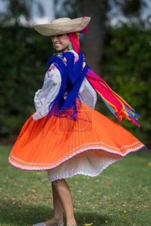 Photo for Manta, Ecuador-- Jan 16, 2023. A Woman in traditional Garb Smiles as she performs a Native Dance - Royalty Free Image