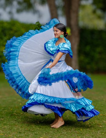 Photo for Manta, Ecuador--January 16, 2023. A young woman performs a folk dance outdoors  in native dress - Royalty Free Image