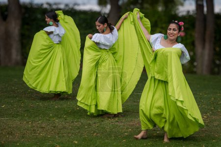 Photo for Manta, Ecuador--January 16, 2023. Three young Ecuadorian women perform a traditional folk dance outdoors. - Royalty Free Image