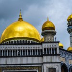 Bandar Seri Begawan, Brunei--March 5, 2023. A telephoto shot of gold domes and a minaret atop the Jame' Asr Hassanil Bolkiah Mosque.
