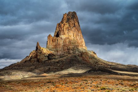 Agathla Peak in Monument Valley, Arizona with moody clouds and dramatic lighting