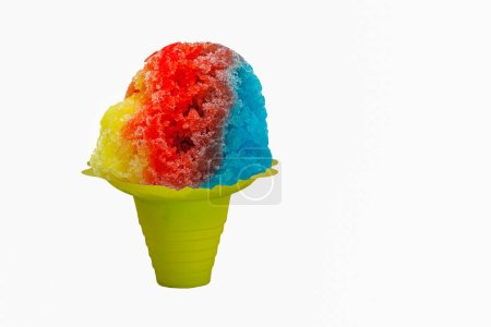 Rainbow Hawaiian Shave ice, shaved ice or snow cone dessert on a white background with copy space.