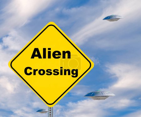 Yellow Diamond Shaped warning road sign, UFO Alien Crossing with flying saucers against a overcast blue sky.