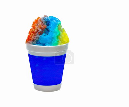 Rainbow Hawaiian Shave Ice, Shaved Ice or a Snow Cone Dessert in a blue and white cup on a white background with copy space.