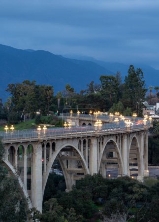Colorado Street Bridge in Pasadena at dusk with lights on