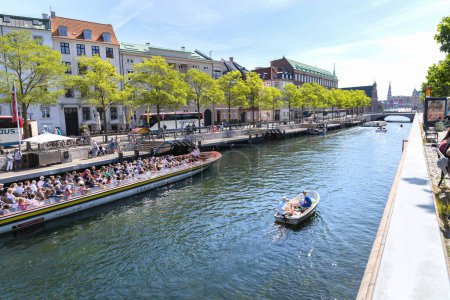 Photo for Slotsholm canal with historic buildings and tourist boats located in the heart of Copenhagen, Denmark - July 26, 2023 - Royalty Free Image
