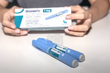 Photo for Female hands holding an insulin pen. Ozempic Insulin injection pen or insulin cartridge pen for diabetics. Medical equipment for diabetes parients. Copenhagen, Denmark - September 4, 2023. - Royalty Free Image