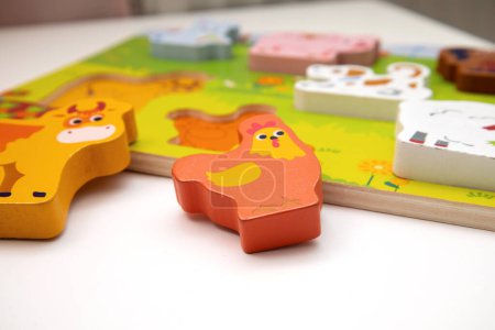 Photo for Children's toys. Puzzle with animals. A child's wooden shape sorter. Logic game for kids. Happy child and fun Games. - Royalty Free Image