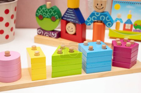 Photo for Children's toys. Logic game for kids. Happy child and fun Games. Day and Night is a fun-filled game of logic. Colourful wooden blocks. Bricks with the pyramid. High quality photo - Royalty Free Image