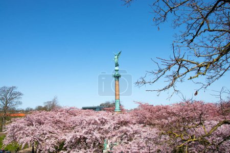 Photo for Copenhagen. Spring. Statue of ancient goddess Victoria with palm branch in hand at Langelinie Park in Copenhagen, Denmark. Cherry blossom in urban park. Sakura Festival. - Royalty Free Image