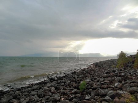 Rocky shore of the sea or lake.The sea of Galilee also called Lake Tiberias or Kinneret, Israel. High quality photo