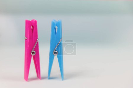 Photo for Blue and pink clothespins. The concept of being different, gender issue, standing out from the crowd, vision of man and woman. - Royalty Free Image