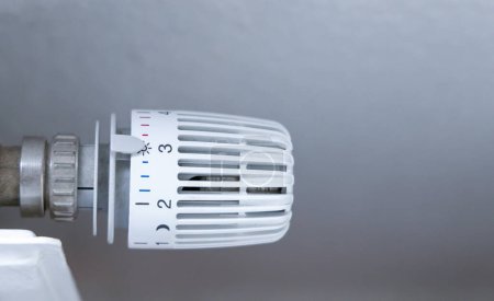 Concept de consommation d'énergie dans les ménages. Régulation de la température de la batterie de chauffage dans la maison avec thermostat sur radiateur blanc. 