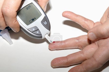 Diabetic man measuring blood sugar level. Blood test for diabetes. High quality photo
