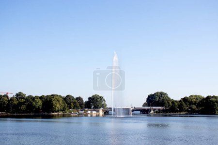 Fountain in the city center of Hamburg, Germany at the bank of Alster Lake. Sunny summer day. Tourism in Germany. 