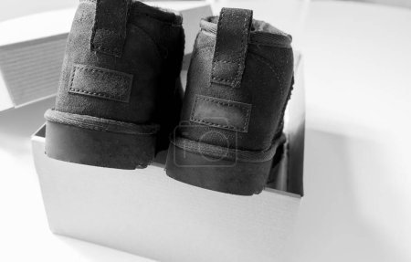 Foto de Las botas a la moda modernas cortas UGG hechas de piel de oveja para el invierno. Foto de alta calidad - Imagen libre de derechos