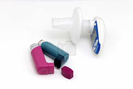 Asthma medications inhalers and peak flow meter on a white background. Lung disease. 