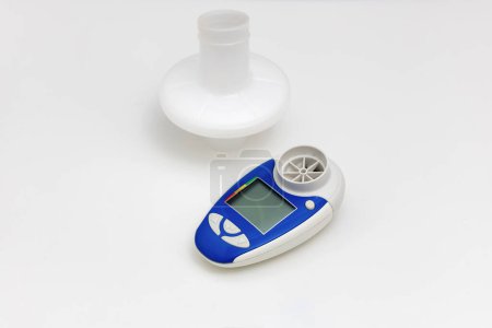 Asthma medications inhalers and peak flow meter on a white background. Lung disease. High quality photo
