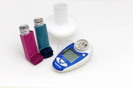  Asthma medications inhalers and peak flow meter on a white background. Lung disease. 