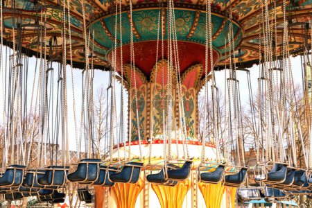 Carousel in an amusement park on a sunny spring day. 