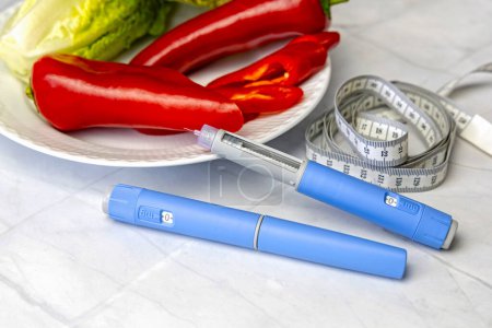 Original Danish Ozempic Insulin injection pen for diabetics and plate with vegetables. High quality photo