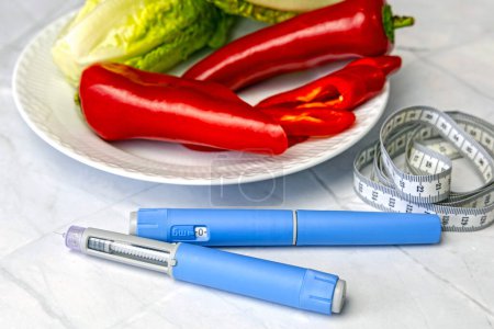 Original dänischer Ozempic Insulin Injektionsstift für Diabetiker und Teller mit Gemüse. Hochwertiges Foto