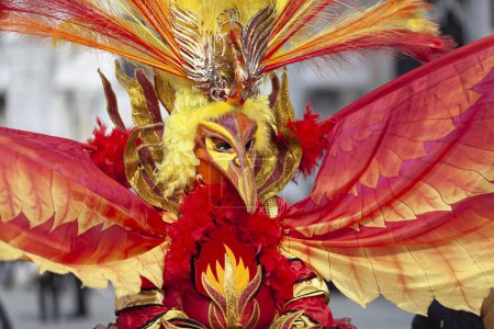 Photo for Venice, Veneto, Italy - February 19, 2020: On the streets of Venezia, Mask Beautiful and Expensive Costume of Phoenix The Bird Of Fire, one of the Symbols of Venice Mythology - Royalty Free Image