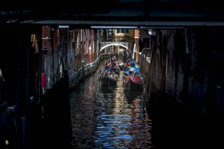 Photo for Venice, Veneto, Italy - February 19, 2020: Gondolas and Gondoliers on Canals of Venezia during celebration of traditional carnival - Royalty Free Image