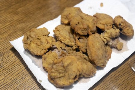 Frayed Bulls Testicles on a Table - Rocky Mountain Oysters Special plate