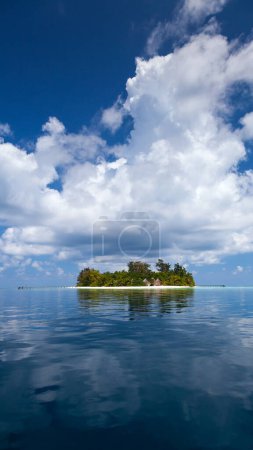 Photo for Old Small Exclusive Tropical Island with two Bungalows from 80's and a Jetty on it from Sea - Luxury Adventure Vacations (bathala island before new acquisition and reconstruction in a modern resort, - Royalty Free Image