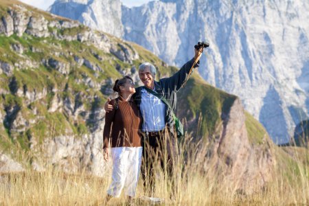 Photo for Serene Senior Caucasian Couple on a Hiking Journey in Mountains Enjoying the View - Royalty Free Image