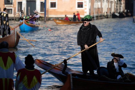 Photo for Venice, Veneto, Italy - January 28, 2024: Participants of Venice Carnival Opening Regatta on Gran Canal are awaiting the Start at at the Punta della Dogana - Royalty Free Image