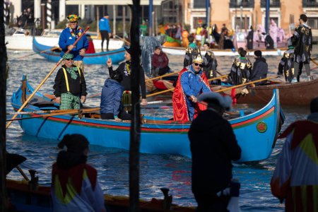 Photo for Venice, Veneto, Italy - January 28, 2024: Participants of Venice Carnival Opening Regatta on Gran Canal are awaiting the Start at at the Punta della Dogana - Royalty Free Image