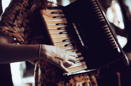 Woman playing the accordion. Close up. 