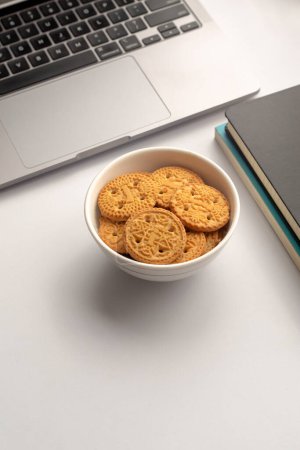 Photo for Butter biscuits. Sweet cookies in plate ,books and laptop - Royalty Free Image