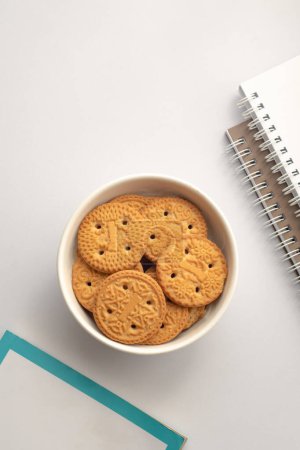 Photo for Butter biscuits. Sweet cookies in plate and notebooks - Royalty Free Image