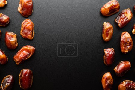 Photo for Top view of  dates on black background, healthy food - Royalty Free Image