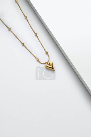 Photo for Luxury golden necklace  with heart pendant, studio shot - Royalty Free Image