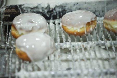 Photo for Freshly fried glazed donuts Donuts with a variety of fillings such as jam, cream, or fruit preserves - Royalty Free Image