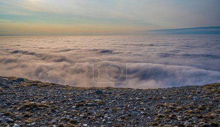 Photo for Rocky cliff and wonderful view of the clouds below - Royalty Free Image