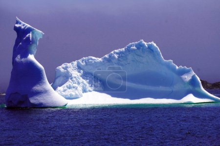 Photo for Large iceberg near the shore on a calm sea under in early summer - Royalty Free Image