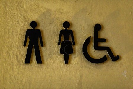 Photo for A toilet sign in Bad Radkersburg Austria. It's a public toilete or wc for everyone. The sign stands out on the bright background wall - Royalty Free Image