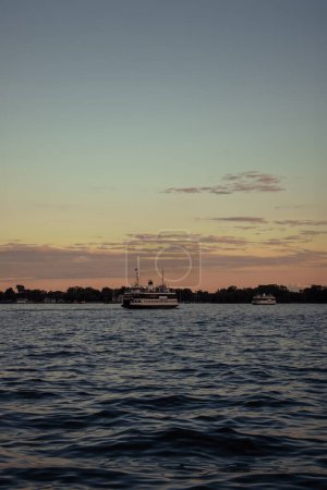 Beautiful sunset over the lake with a ferry in the foreground. Lake Ontario, Canada. 
