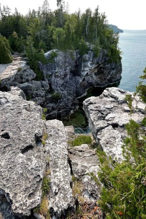 View from the top of a cliff to the lake and forest. Tobermory, Canada.